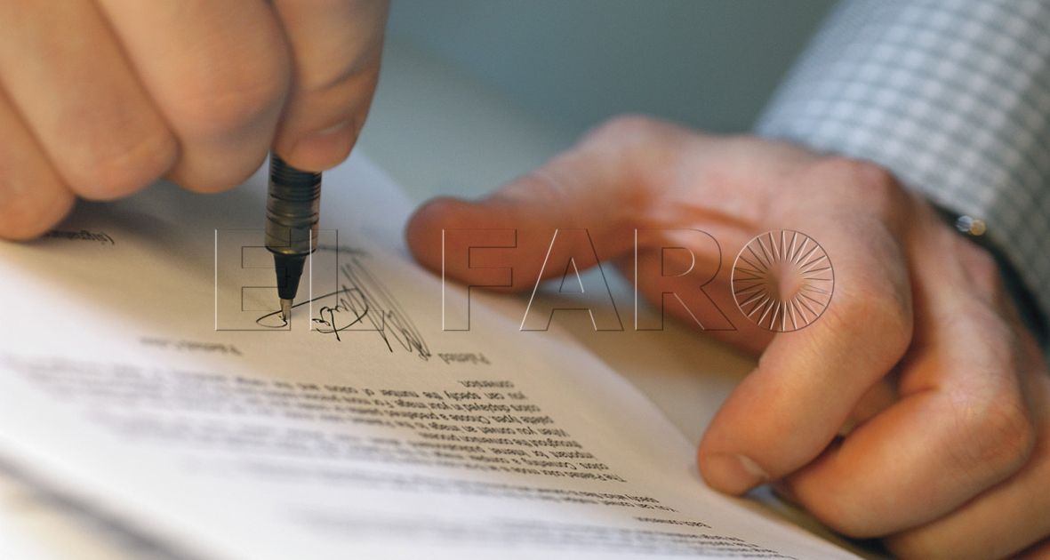 Man's Hands Signing Document --- Image by © Royalty-Free/Corbis
