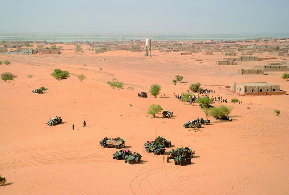 (FILES) -- A file photo taken on February 17, 2013 shows French soldiers taking position outside Bourem, northern Mali. France said on July 13, 2014 its military offensive that freed northern Mali from the grip of Islamists would be replaced by an operation spanning the wider, largely lawless Sahel region to combat extremist violence. The so-called Serval offensive kicked off in January last year when French troops came to the help of Malian soldiers to rid the country's vast desert north from Islamists and Tuareg rebels who seized control after a coup.AFP PHOTO /POOL / PASCAL GUYOT