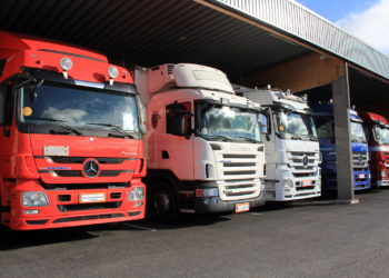 Mercedes-benz And Scania Trucks In A Carport
