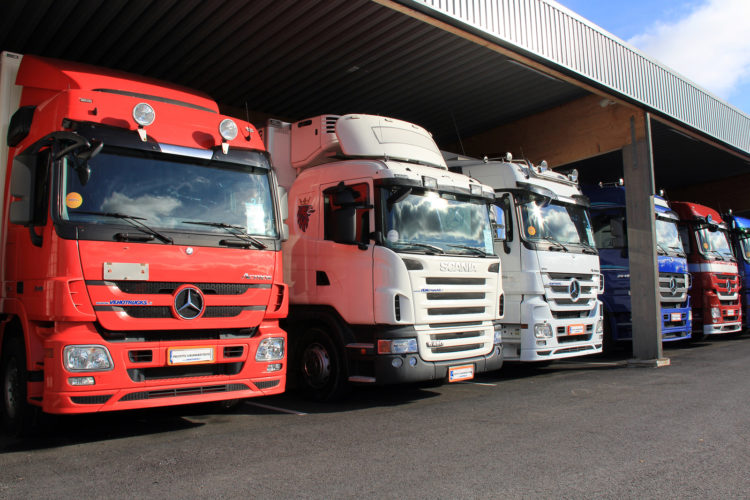 Mercedes-benz And Scania Trucks In A Carport
