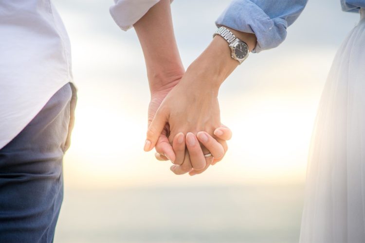 Couple holding hands