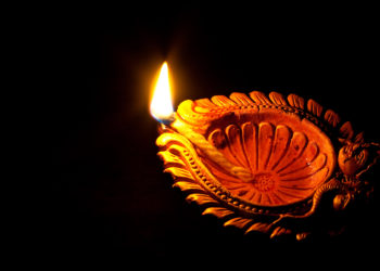 The festival of lamps is here.  Taken at home. using an oil lamp, a black backgroun. The lamp is placed on glass and little bit of painting by a pen torch is used to illuminate the faces (of Ganapathi or Lord Ganesh and Devi).   Deepavali is a Sanskrit word - Deepa meaning light and Avali, meaning a row.  In Hinduism, across many parts of India and Nepal, it is the homecoming of Rama after a 14-year exile in the forest and his victory over Ravana.[5] In the legend, the people of Ayodhya (the capital of his kingdom) welcomed Rama by lighting rows (avali) of lamps (dĭpa). - taken from Wikipedia (http://en.wikipedia.org/wiki/Deepavali)